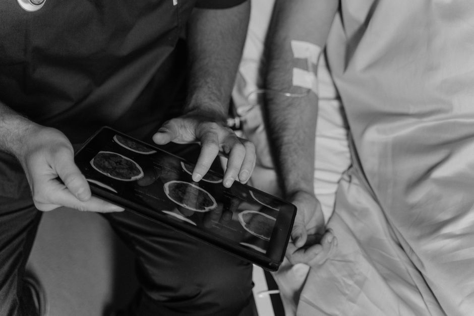 Surgeon reviewing a medical scan with a patient