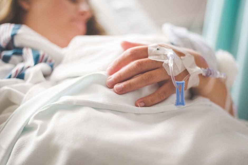 Patient resting comfortably in a hospital bed after surgery