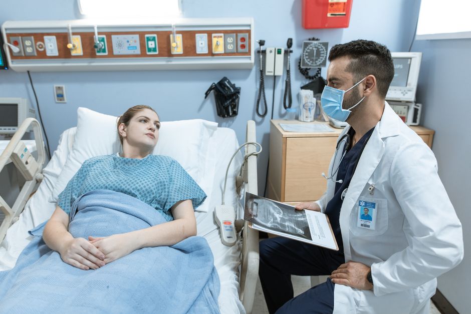 Doctor explaining surgical options to a patient using a chart