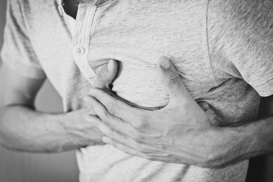 Woman experiencing chest discomfort from acid reflux