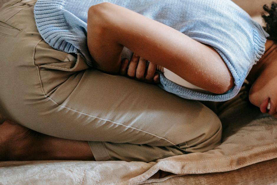Woman feeling unwell and holding her stomach