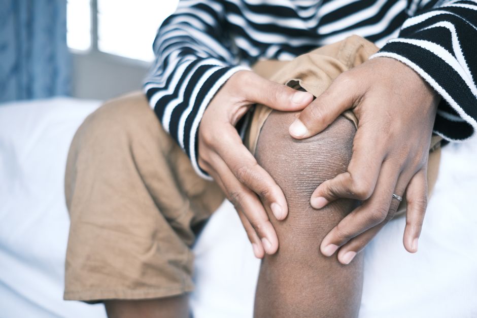 Person experiencing knee pain from excess joint load