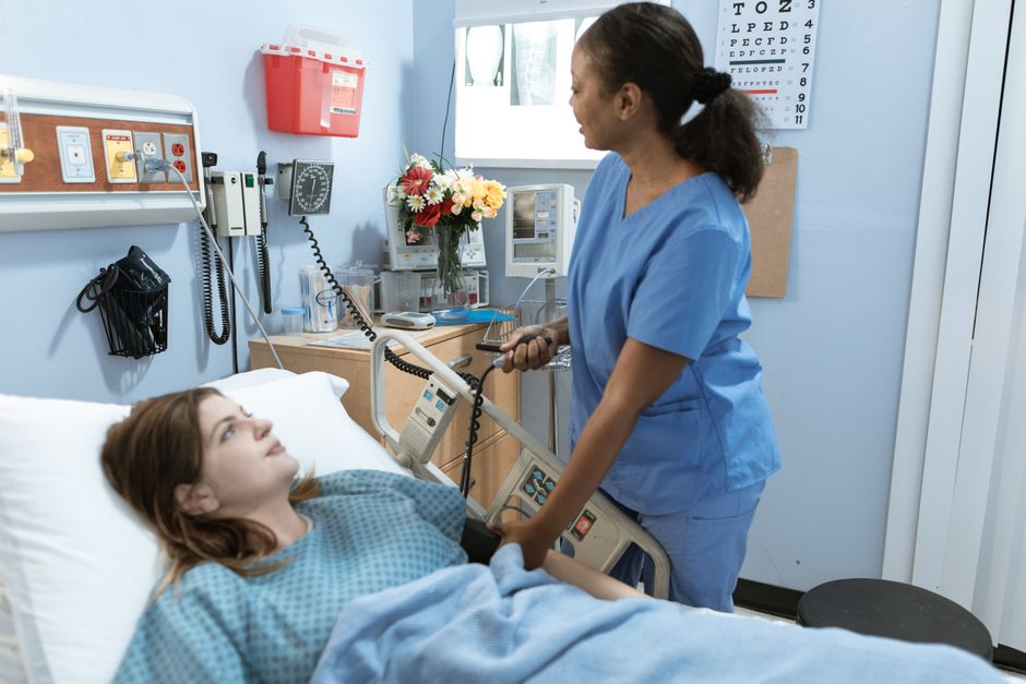 Patient walking with support during early laparoscopic surgery recovery