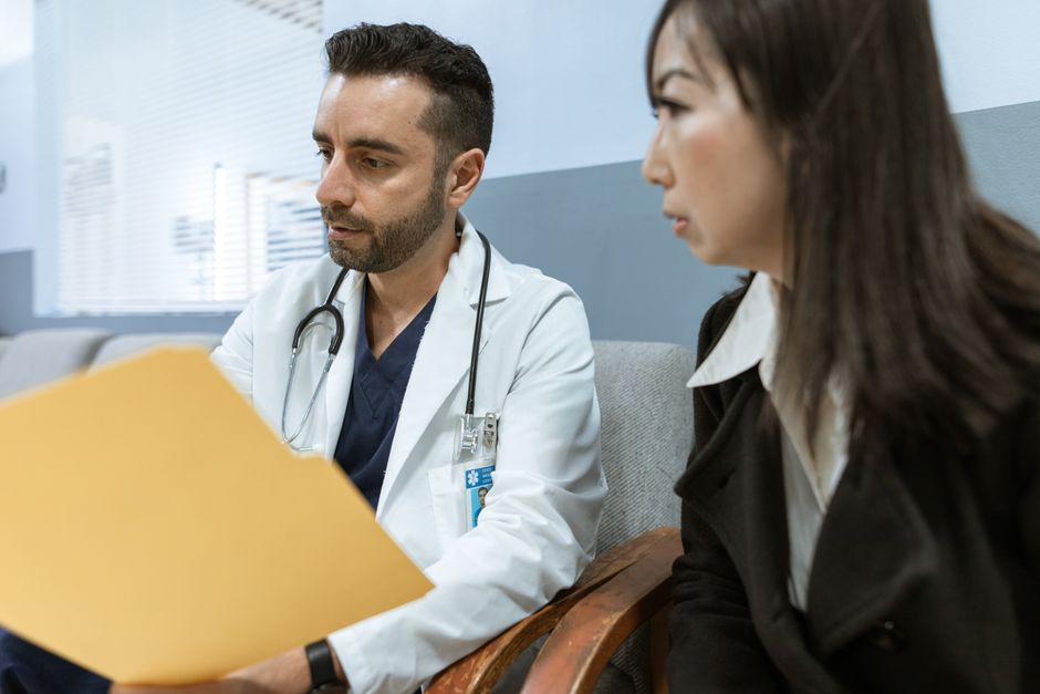 Surgeon discussing skin removal surgery options with a patient