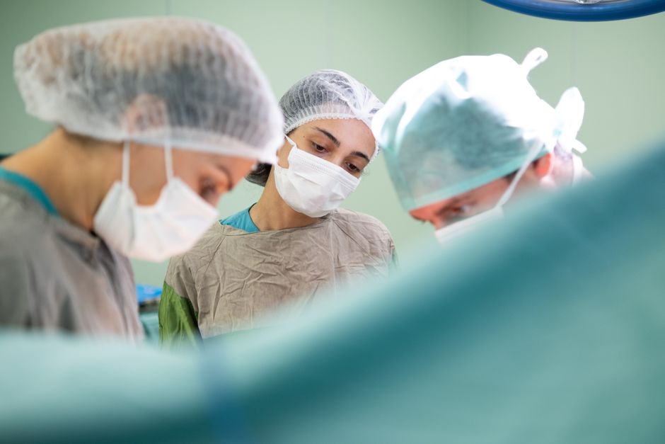Experienced surgeon reviewing a patient case before surgery