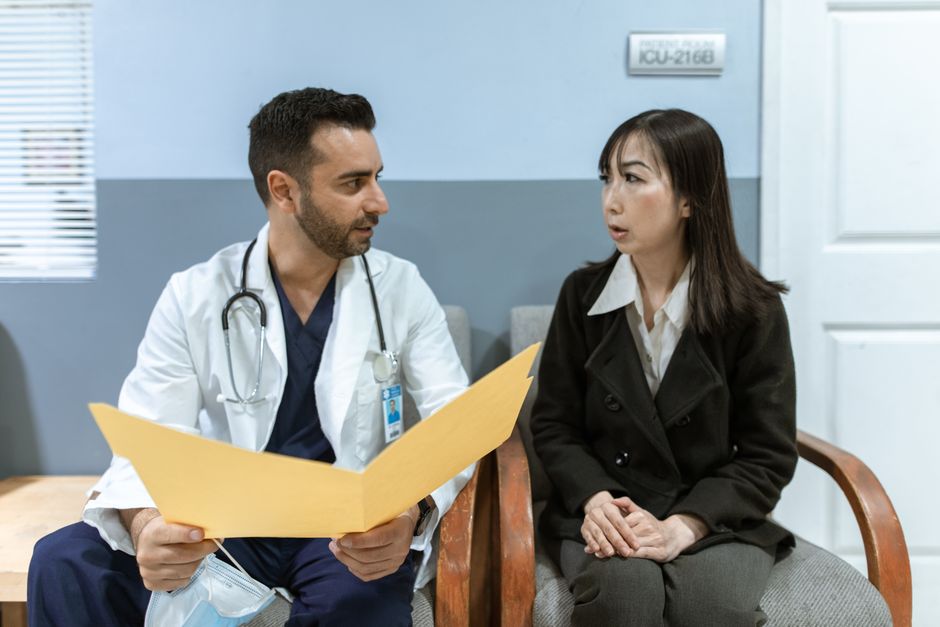 Surgeon reviewing bariatric surgery options with a patient using a body diagram
